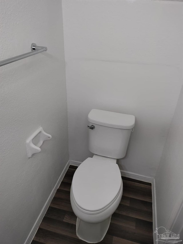 bathroom featuring hardwood / wood-style flooring and toilet