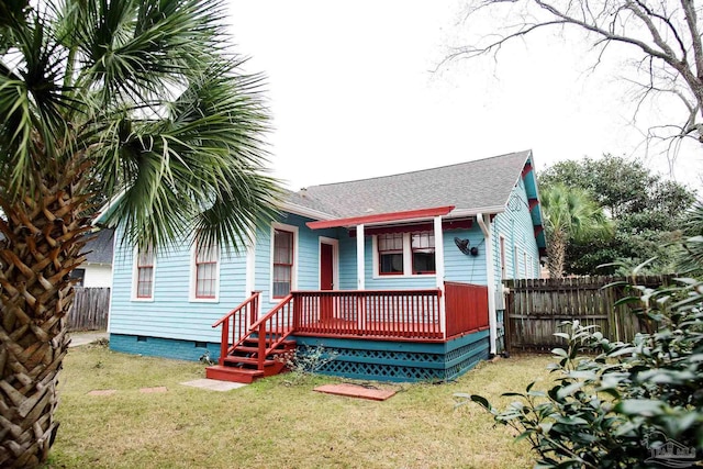 back of property featuring a lawn