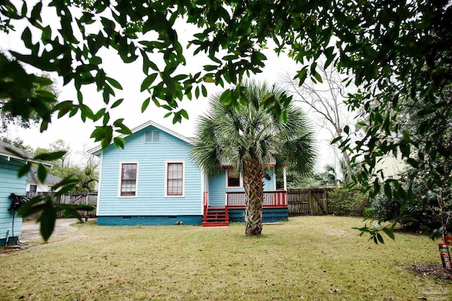 back of property featuring a lawn