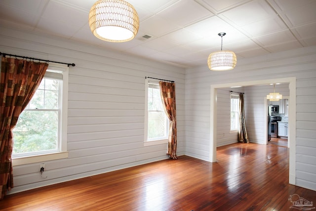 spare room featuring wood-type flooring