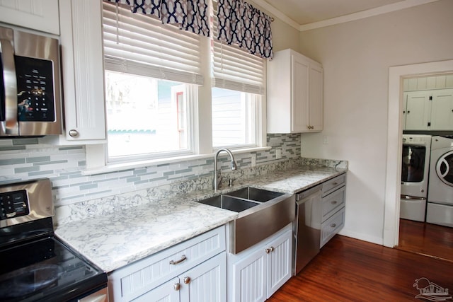 kitchen with white cabinetry, separate washer and dryer, sink, light stone counters, and stainless steel appliances