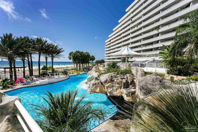 view of swimming pool featuring a water view