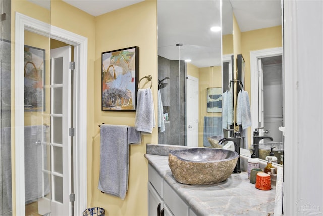 bathroom featuring vanity and a tile shower