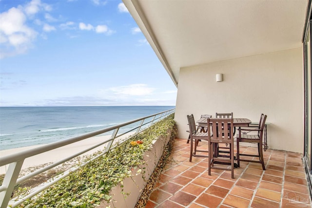 balcony with a water view and a beach view