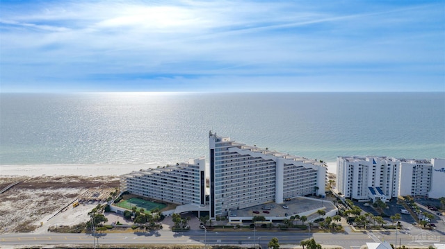 drone / aerial view featuring a beach view and a water view