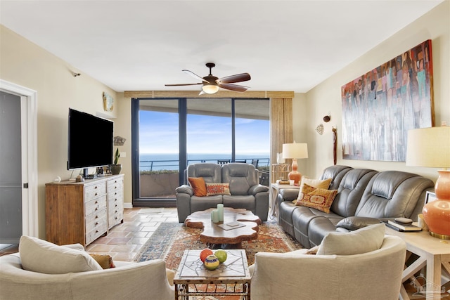 living room featuring a wall of windows and ceiling fan