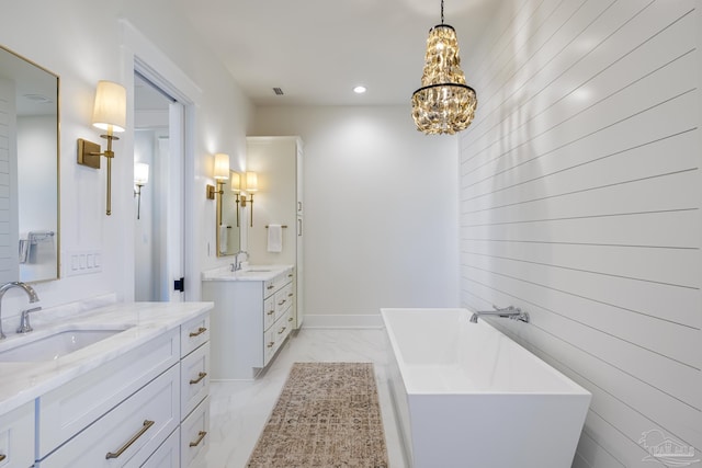 bathroom featuring a bathtub, vanity, and an inviting chandelier