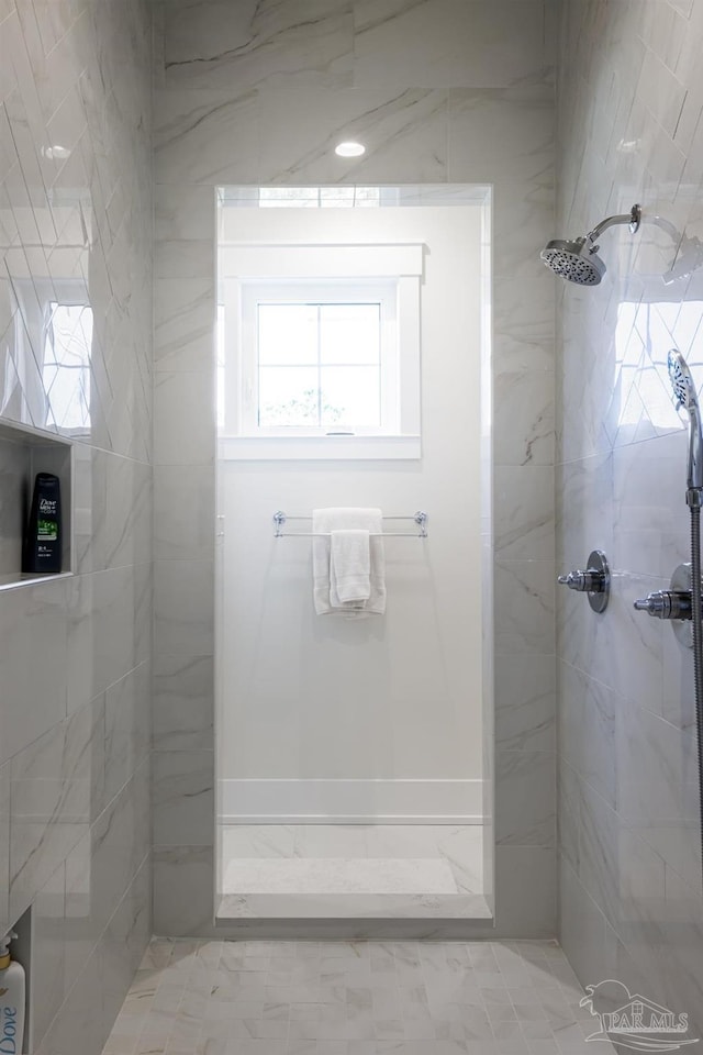 bathroom with tiled shower