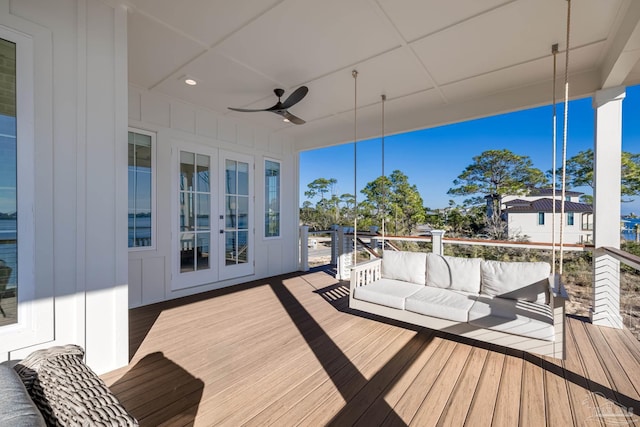 wooden deck with ceiling fan, french doors, and an outdoor hangout area