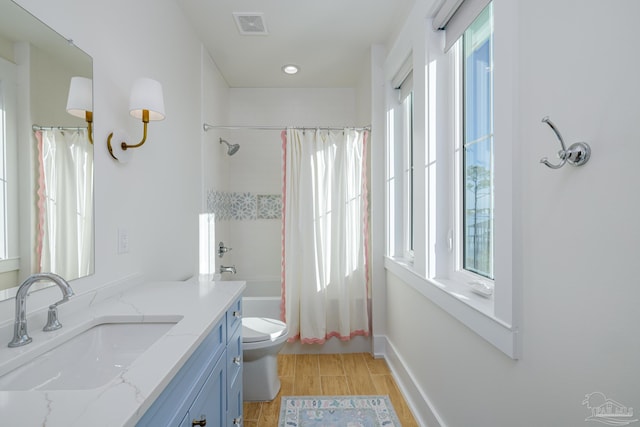 full bathroom with hardwood / wood-style flooring, vanity, toilet, and shower / bathtub combination with curtain