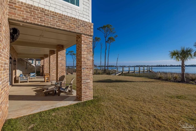 view of yard featuring a water view and a patio