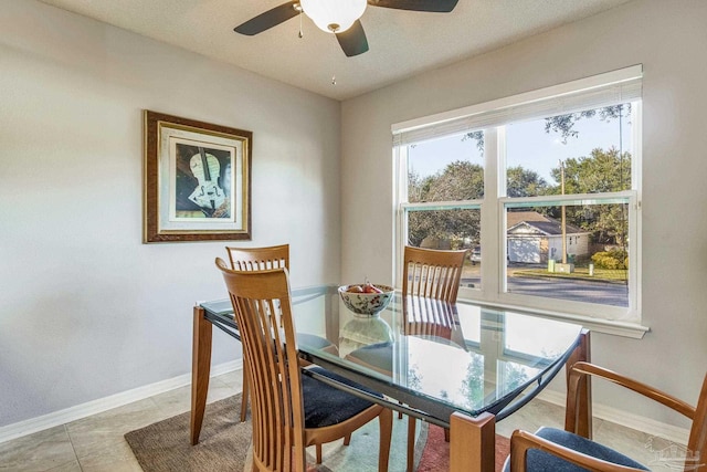 dining area with tile patterned floors and ceiling fan