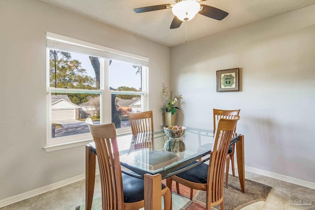 dining room with ceiling fan, light tile patterned floors, and a textured ceiling