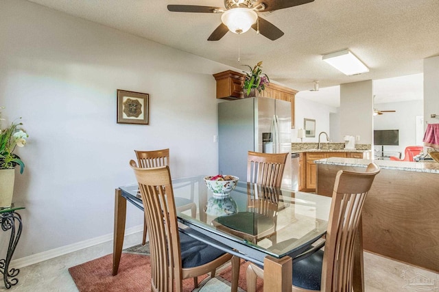 dining area with sink and a textured ceiling