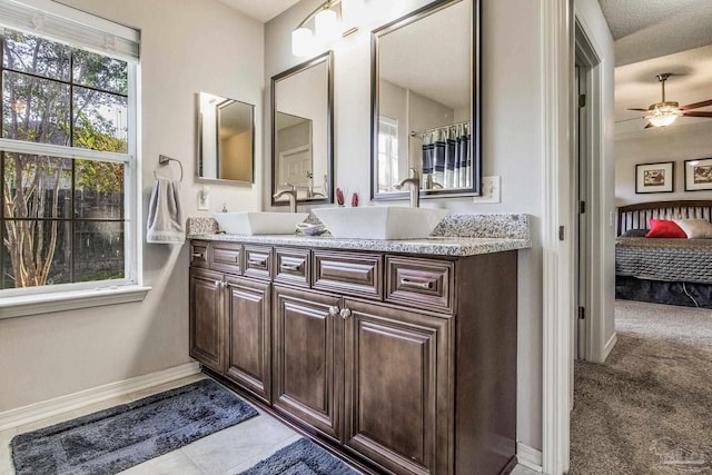 bathroom featuring a textured ceiling, vanity, and ceiling fan