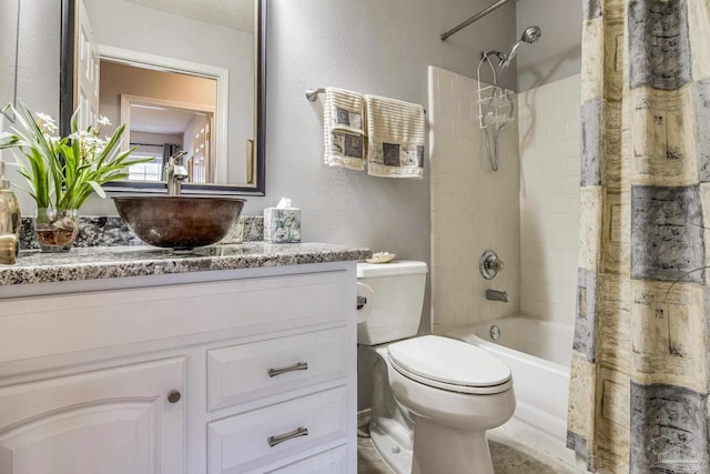 full bathroom featuring shower / tub combo, vanity, and toilet