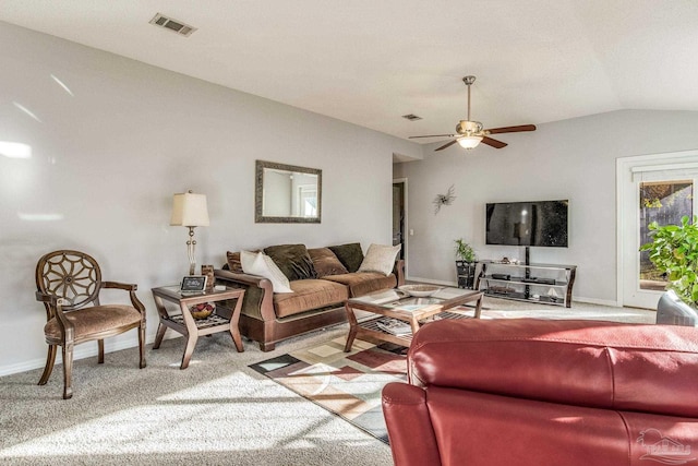 carpeted living room with ceiling fan and vaulted ceiling