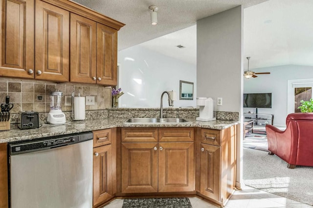 kitchen featuring sink, light tile patterned flooring, stainless steel dishwasher, and lofted ceiling