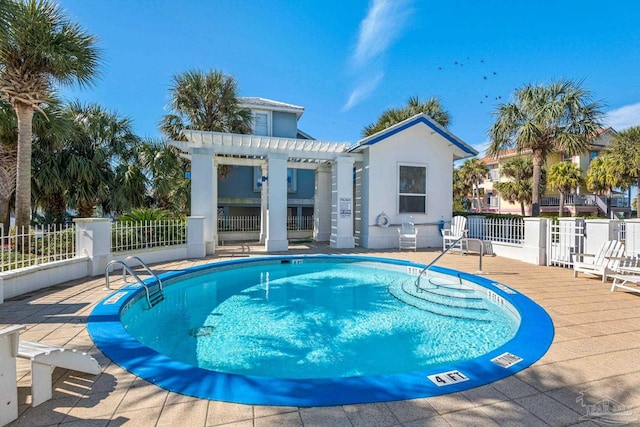 view of swimming pool with a patio area and a pergola