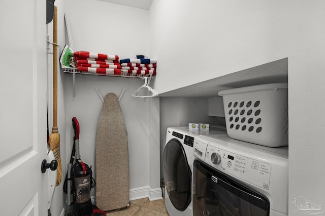 laundry area featuring light tile patterned floors and washer and dryer