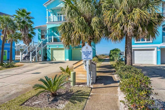 coastal inspired home featuring a garage and a balcony