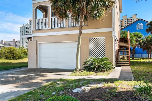 view of front of home with a balcony and a garage