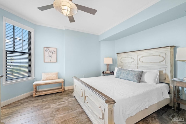 bedroom featuring ceiling fan, wood-type flooring, and crown molding