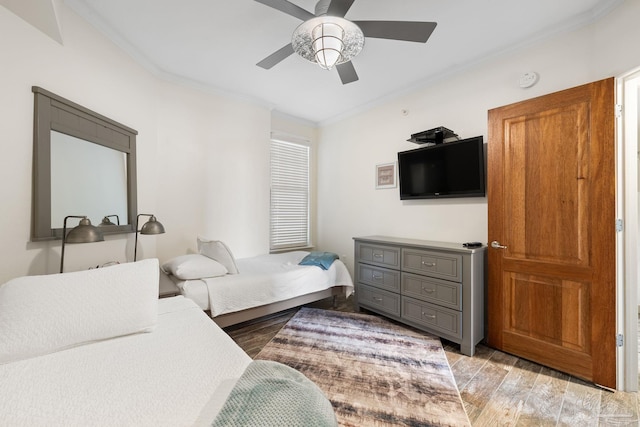 bedroom with ceiling fan, light hardwood / wood-style flooring, and crown molding