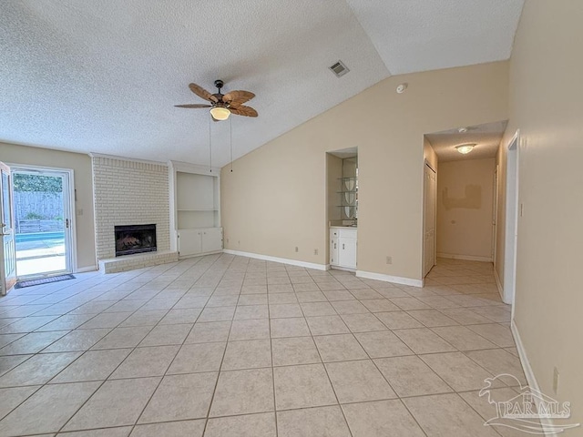 4514 Southpointe Ln, Pensacola, FL 32514 - unfurnished living room featuring a ceiling fan, a textured ceiling, vaulted ceiling, light tile patterned floors, and a fireplace