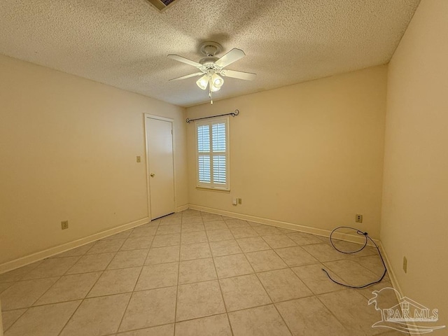 4514 Southpointe Ln, Pensacola, FL 32514 - unfurnished room featuring ceiling fan, a textured ceiling, light tile patterned floors, and baseboards
