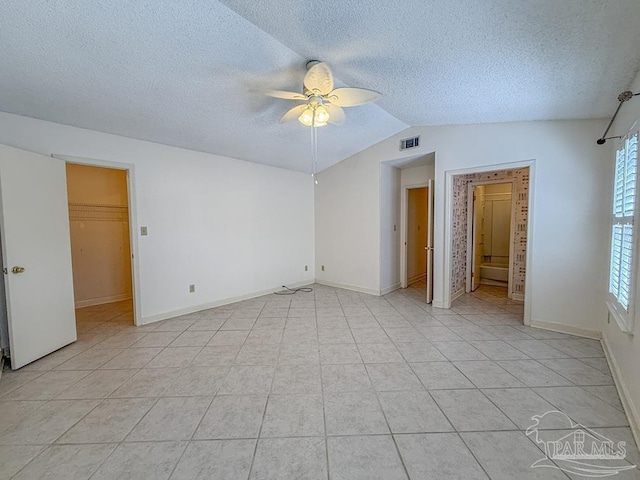 4514 Southpointe Ln, Pensacola, FL 32514 - unfurnished bedroom with lofted ceiling, a textured ceiling, light tile patterned floors, baseboards, and ceiling fan