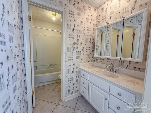 4514 Southpointe Ln, Pensacola, FL 32514 - bathroom with wallpapered walls, a textured ceiling, vanity, tile patterned floors, and toilet