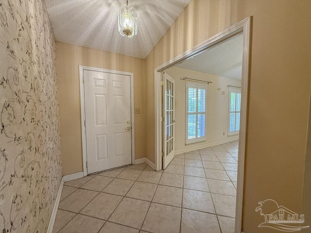 4514 Southpointe Ln, Pensacola, FL 32514 - entryway featuring light tile patterned floors, a textured ceiling, and baseboards