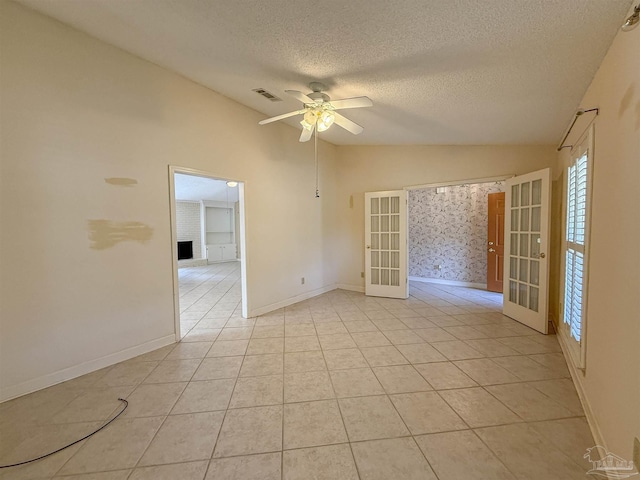 4514 Southpointe Ln, Pensacola, FL 32514 - unfurnished room with french doors, vaulted ceiling, a textured ceiling, a ceiling fan, and light tile patterned flooring