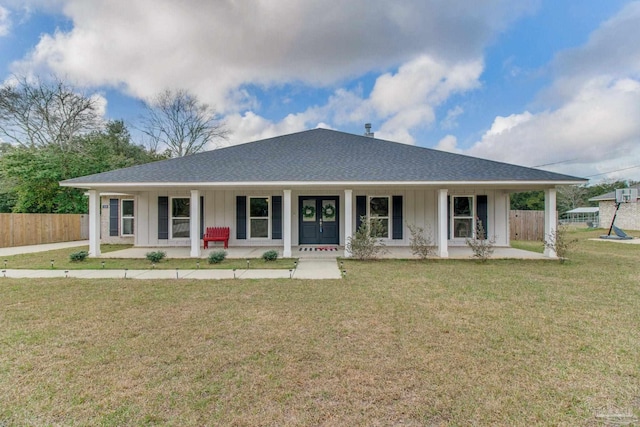 view of front of house with a front lawn, fence, a porch, and board and batten siding