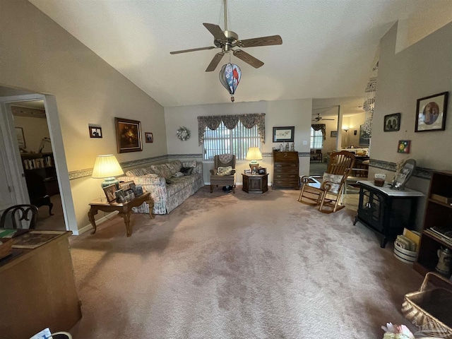 living room with carpet floors, high vaulted ceiling, and ceiling fan