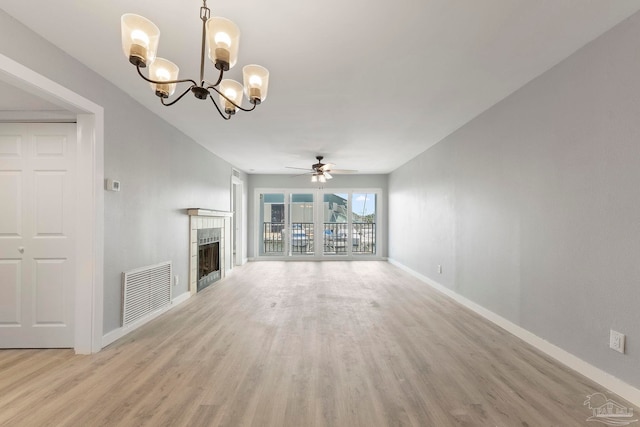 14100 River Rd Unit 223B, Pensacola, FL 32507 - unfurnished living room featuring ceiling fan, light wood finished floors, baseboards, a chandelier, and a tiled fireplace