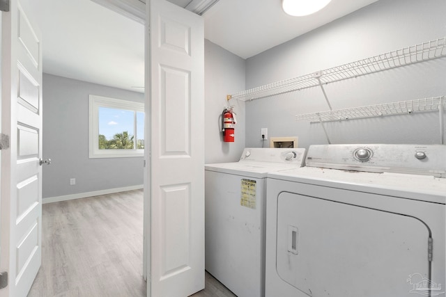 14100 River Rd Unit 223B, Pensacola, FL 32507 - washroom with washer and dryer, light wood finished floors, and baseboards