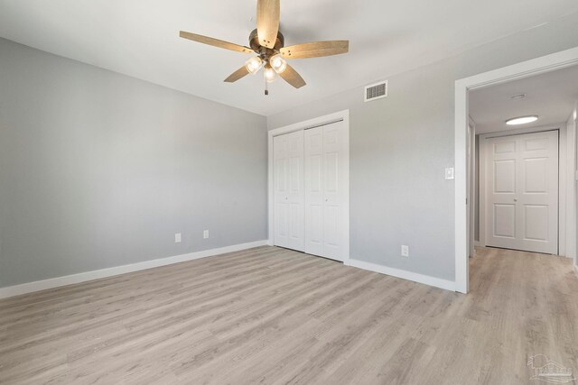 14100 River Rd Unit 223B, Pensacola, FL 32507 - unfurnished bedroom featuring light wood-style floors, baseboards, a closet, and ceiling fan