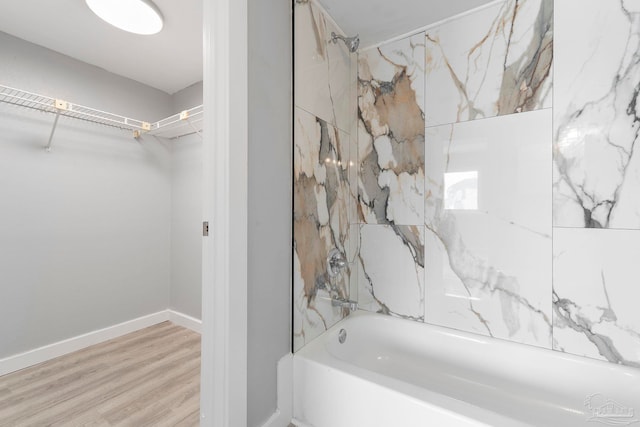 14100 River Rd Unit 223B, Pensacola, FL 32507 - full bathroom featuring shower / bath combination, wood finished floors, a spacious closet, and baseboards