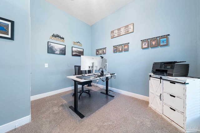 carpeted home office with a textured ceiling