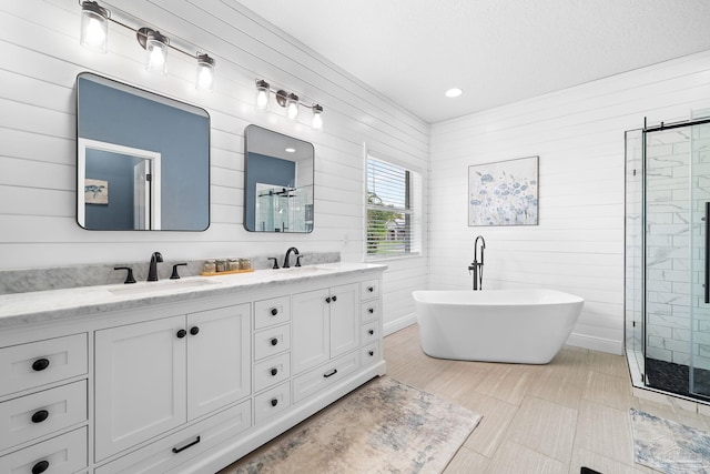 bathroom featuring independent shower and bath, vanity, and tile patterned flooring