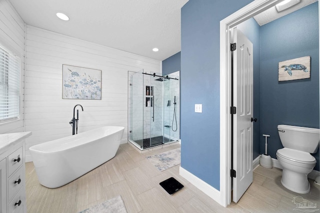 full bathroom with vanity, a textured ceiling, toilet, and separate shower and tub