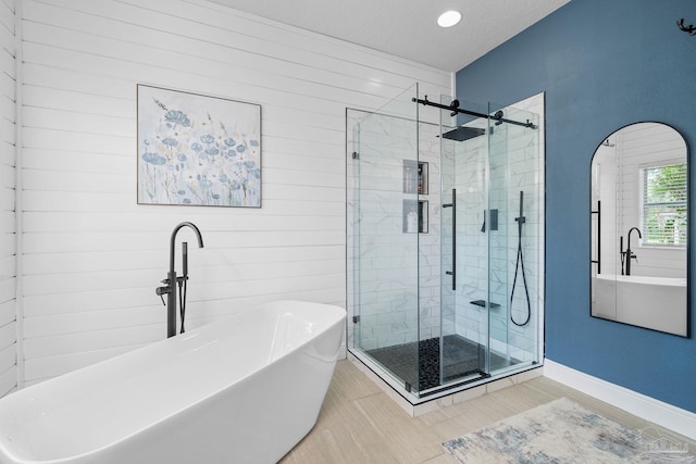 bathroom featuring independent shower and bath and a textured ceiling