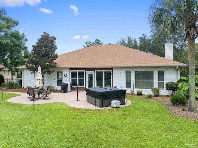 back of house featuring a yard and a patio area