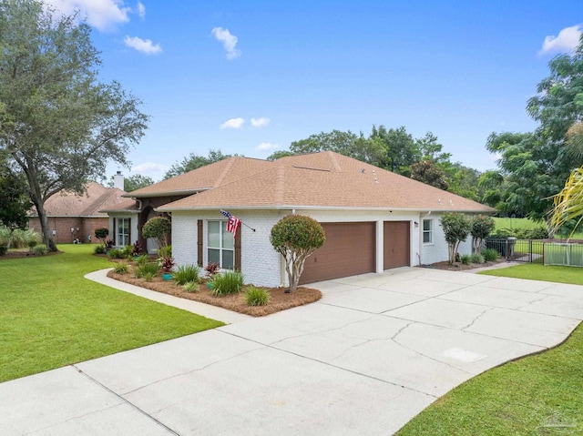 view of front of property featuring a garage and a front lawn