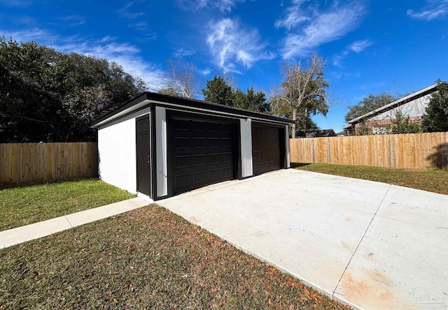 garage featuring a lawn