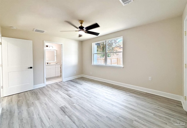 unfurnished bedroom featuring connected bathroom, light hardwood / wood-style floors, and ceiling fan