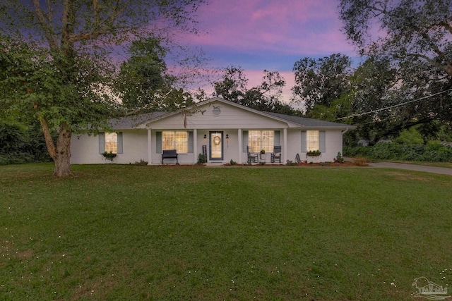 ranch-style home with a porch and a front lawn