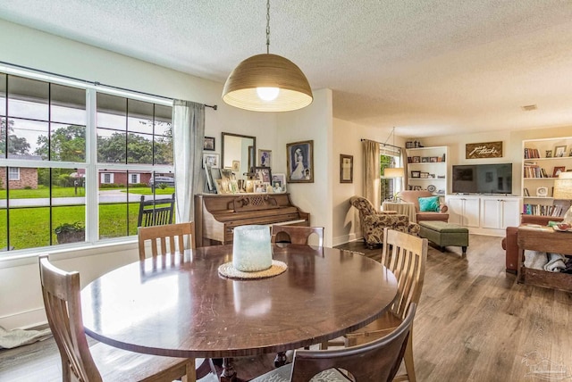 2519 Inda Ave, Pensacola, FL 32526 - dining room featuring baseboards, a textured ceiling, and wood finished floors